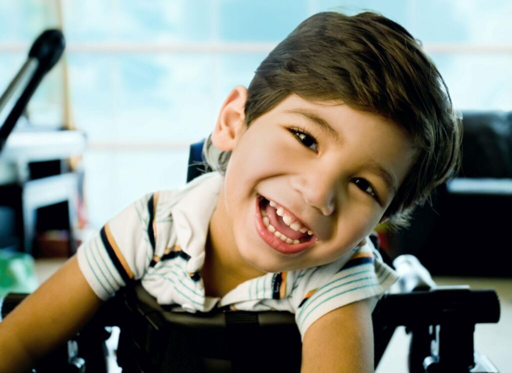 child smiling sitting in chair